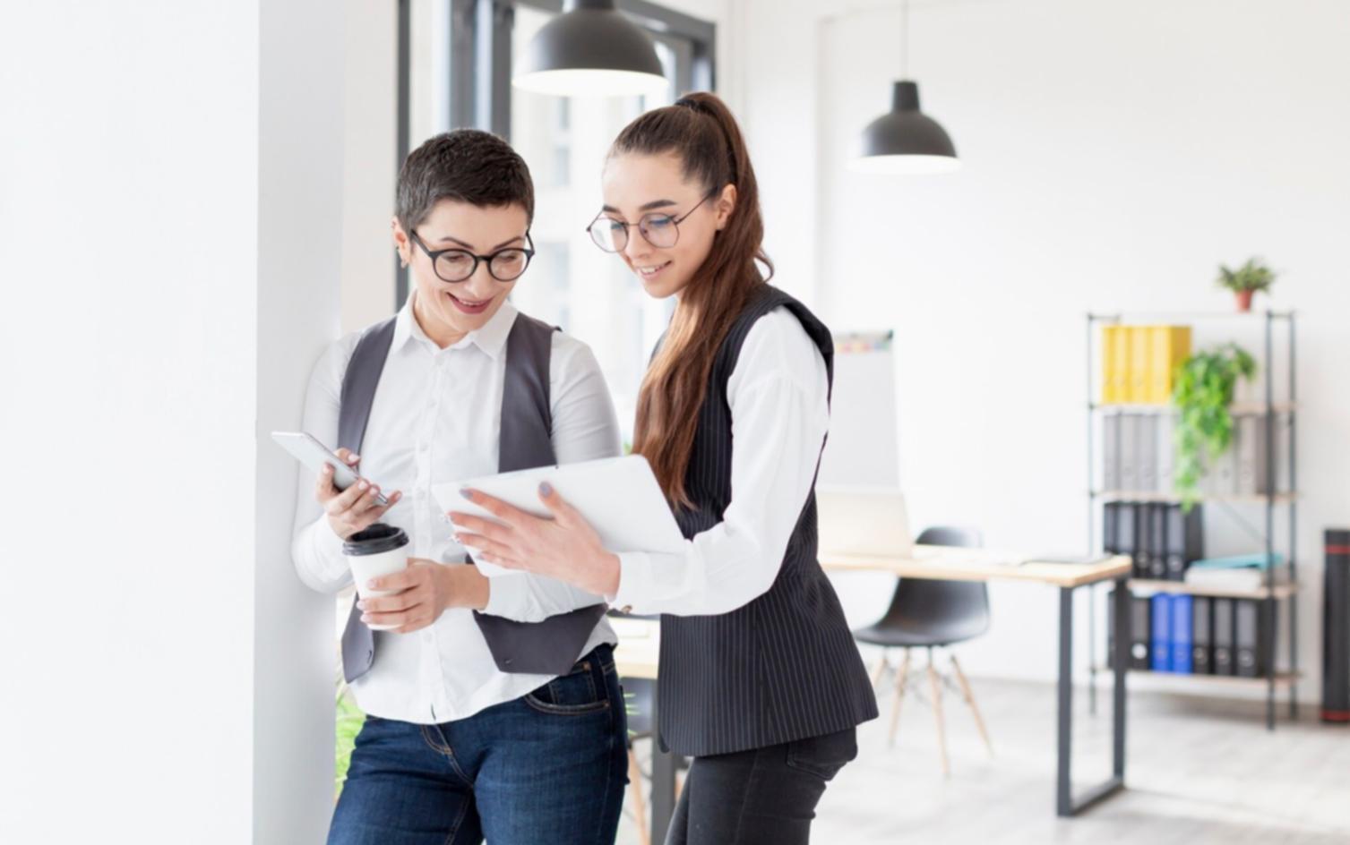 Collaborative workspace with entrepreneurs working on laptops and documents